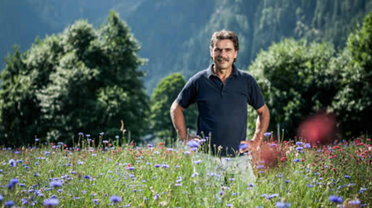 Reto Raselli in a field of herbs